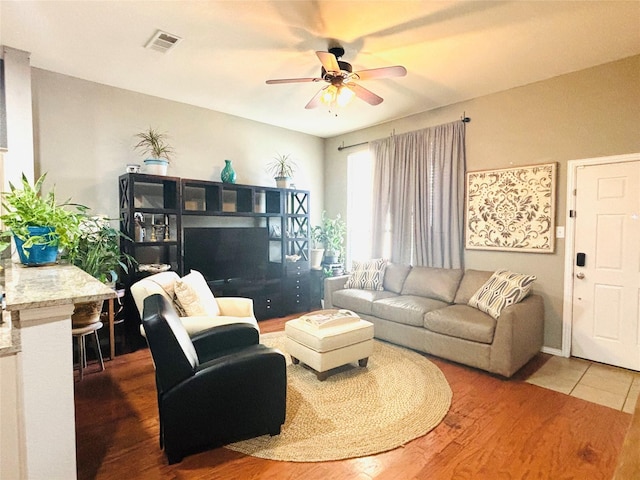 living room featuring ceiling fan and wood-type flooring