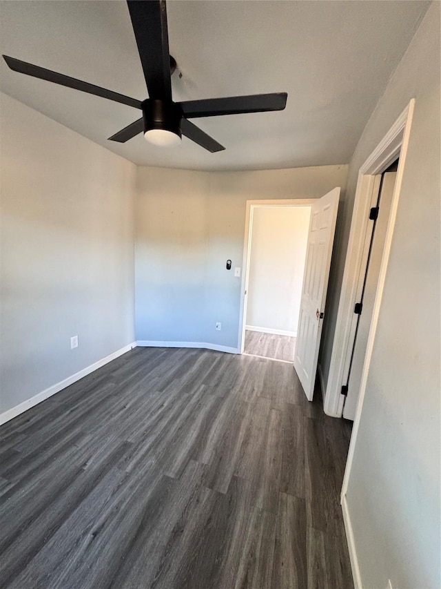 empty room with dark wood-type flooring and ceiling fan