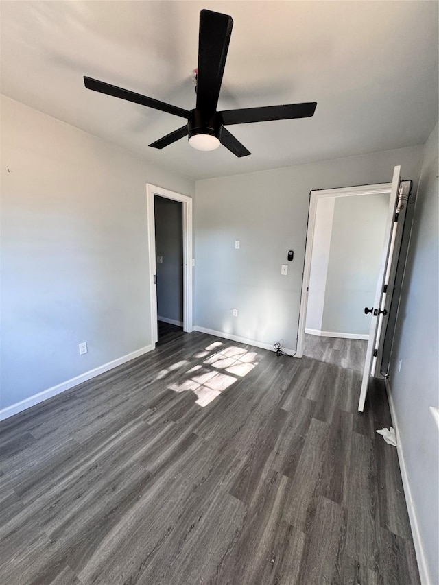 empty room featuring ceiling fan and dark wood-type flooring