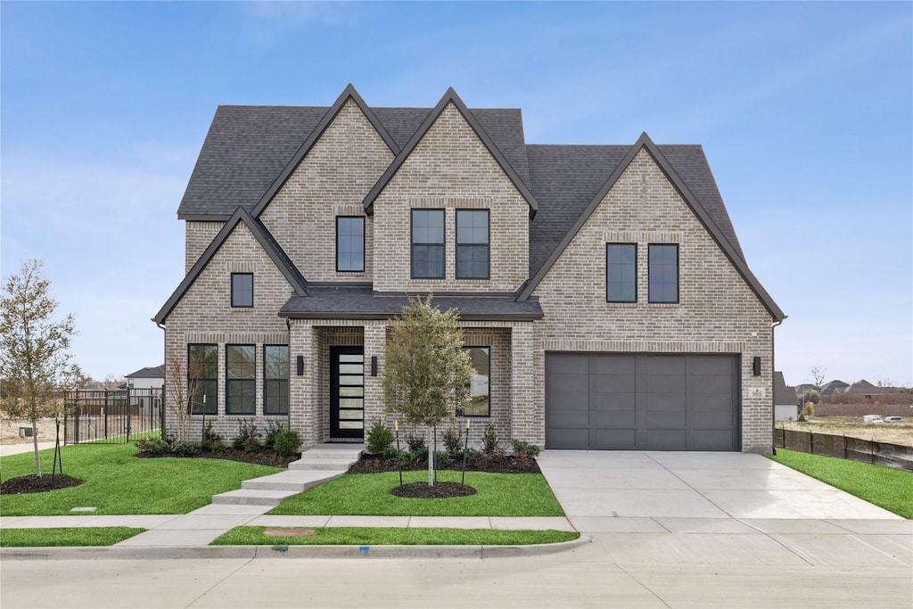 view of front facade with a garage and a front lawn