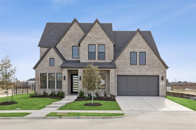 view of front of house with a garage and a front lawn