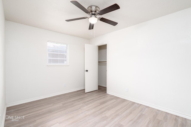 unfurnished bedroom with a closet, light hardwood / wood-style flooring, and ceiling fan