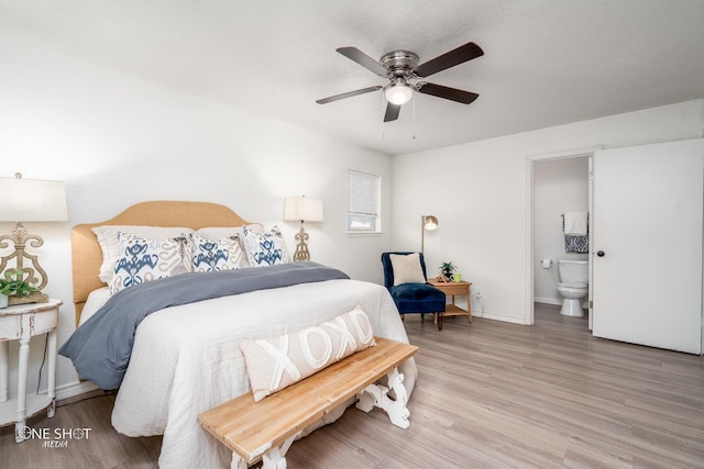 bedroom with wood-type flooring, ensuite bathroom, and ceiling fan