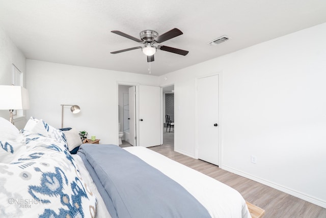 bedroom with ceiling fan, light wood-type flooring, and a textured ceiling