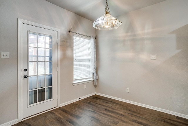 doorway to outside featuring a chandelier and dark hardwood / wood-style floors