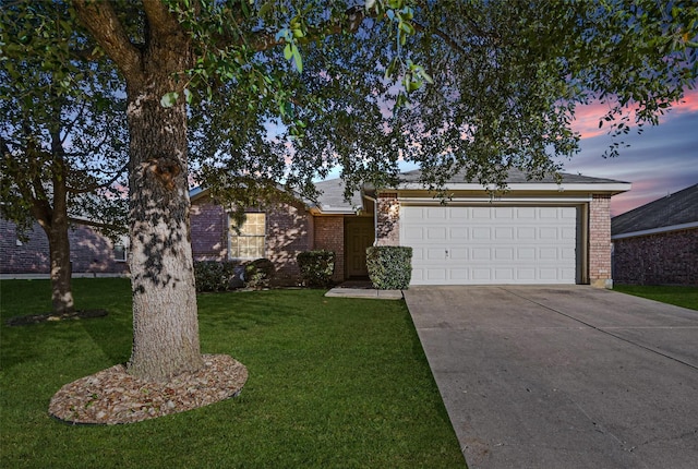 ranch-style home with a garage and a yard