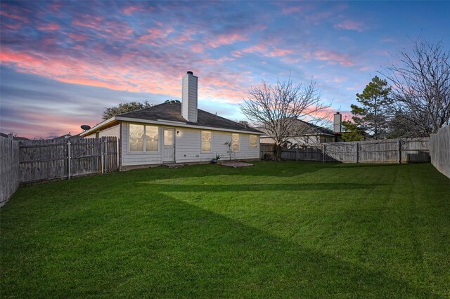 ranch-style home with a yard and a garage