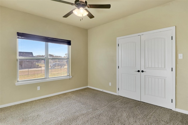 unfurnished bedroom featuring a closet, ceiling fan, and carpet flooring