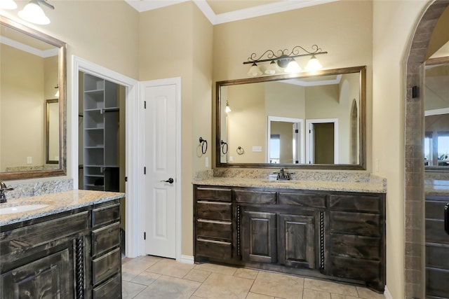 bathroom with tile patterned flooring, crown molding, and vanity