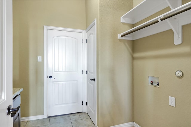 laundry room featuring light tile patterned flooring and washer hookup