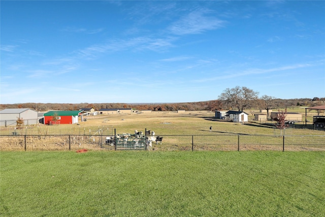 view of yard featuring a rural view and a storage unit