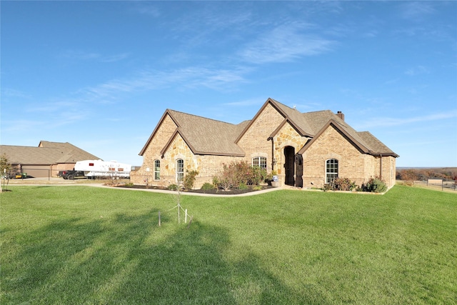 french country style house featuring a front yard