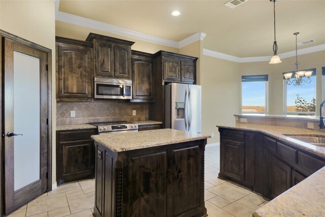 kitchen featuring dark brown cabinetry, a chandelier, decorative light fixtures, a kitchen island, and appliances with stainless steel finishes