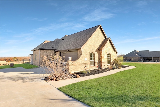 view of property exterior with a garage and a lawn