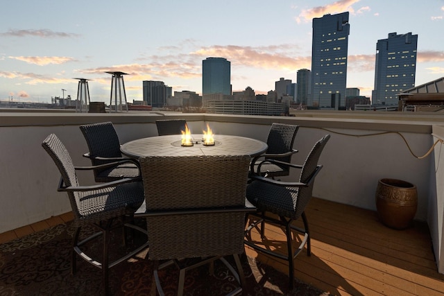 deck at dusk with a fire pit