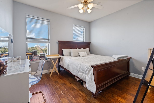 bedroom with multiple windows, ceiling fan, and dark wood-type flooring