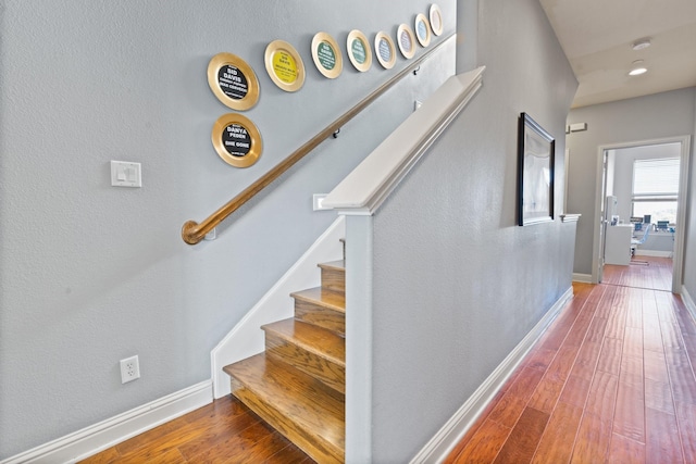 stairway with hardwood / wood-style floors