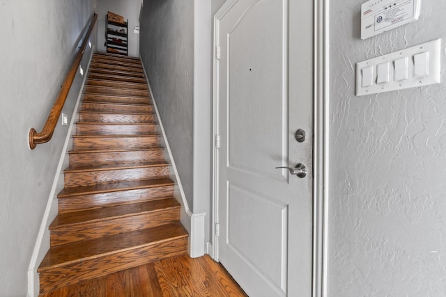 staircase featuring hardwood / wood-style flooring