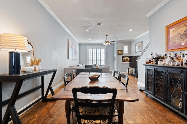 dining space featuring hardwood / wood-style flooring, ceiling fan, and ornamental molding