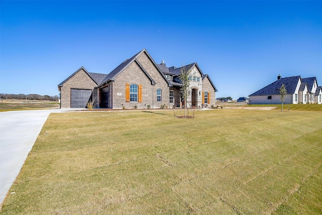 view of front of property with a garage and a front yard