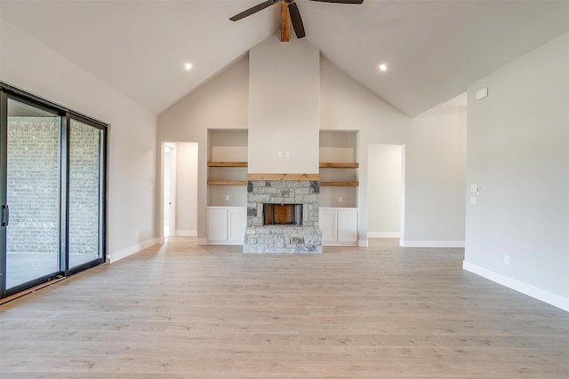 unfurnished living room with high vaulted ceiling, light hardwood / wood-style flooring, ceiling fan, built in features, and a fireplace