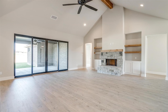 unfurnished living room with light wood-type flooring, built in shelves, ceiling fan, high vaulted ceiling, and a fireplace