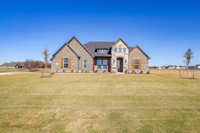 french country home featuring a front yard