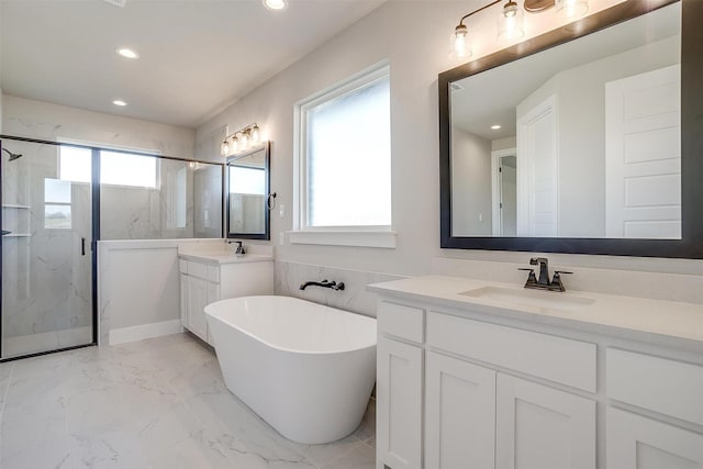 bathroom with plenty of natural light, shower with separate bathtub, and vanity