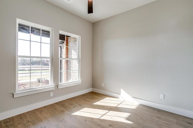 unfurnished room featuring light hardwood / wood-style flooring and ceiling fan