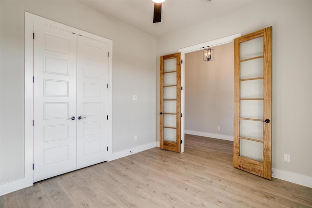 unfurnished bedroom with light wood-type flooring, a closet, and ceiling fan