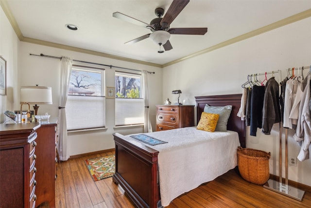 bedroom with crown molding, ceiling fan, and hardwood / wood-style floors