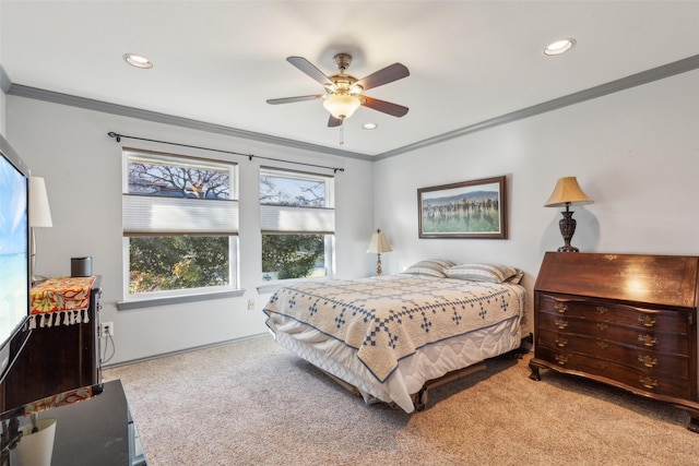 carpeted bedroom with ornamental molding and ceiling fan