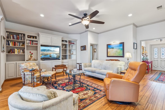 living room with ornamental molding, ceiling fan, and light hardwood / wood-style floors