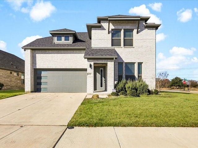 view of front facade with a garage and a front yard