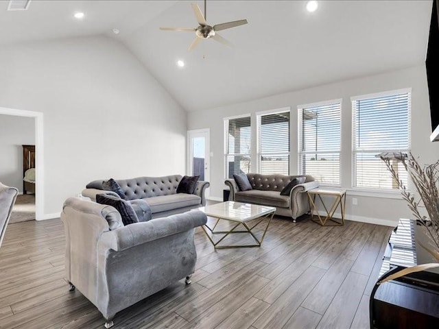 living room featuring hardwood / wood-style flooring, high vaulted ceiling, and ceiling fan