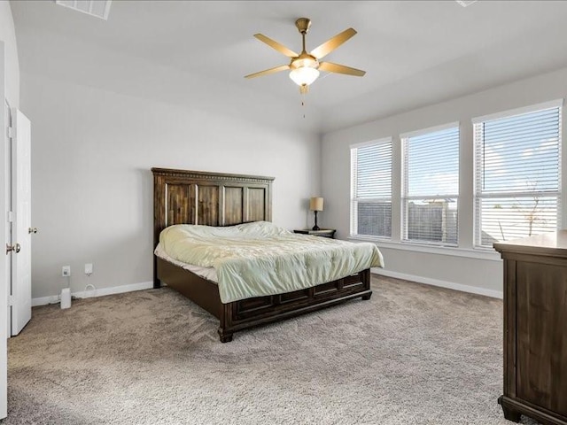 bedroom with ceiling fan and light carpet