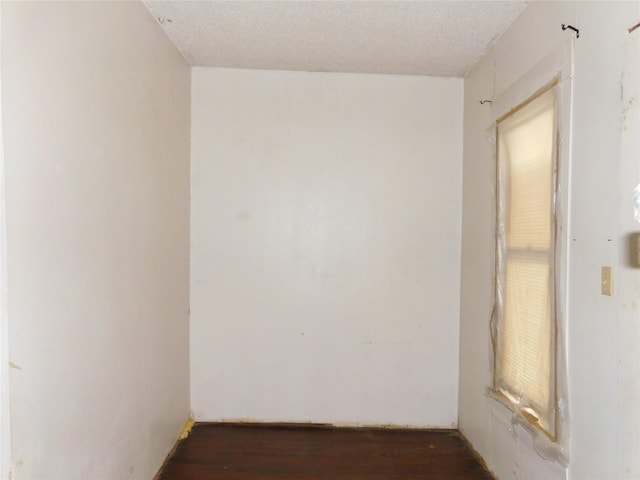 unfurnished room featuring a textured ceiling