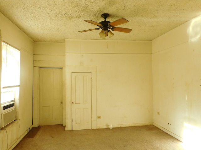 unfurnished room featuring ceiling fan and a textured ceiling