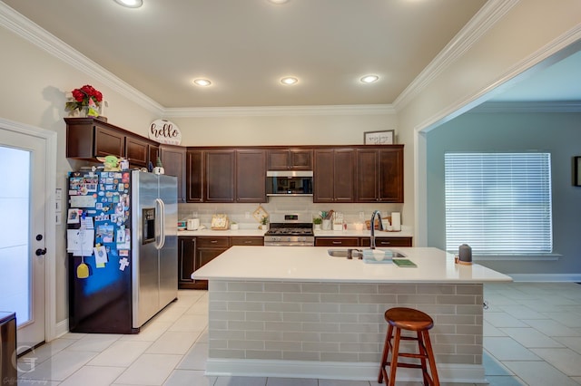 kitchen featuring a sink, stainless steel appliances, light countertops, dark brown cabinets, and backsplash