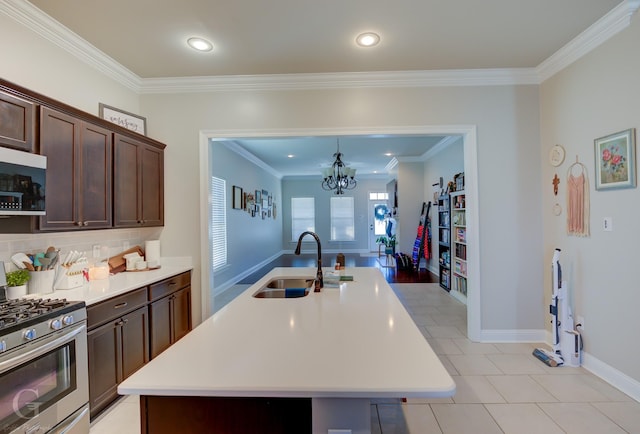 kitchen with a sink, dark brown cabinetry, stainless steel range with gas stovetop, and light countertops