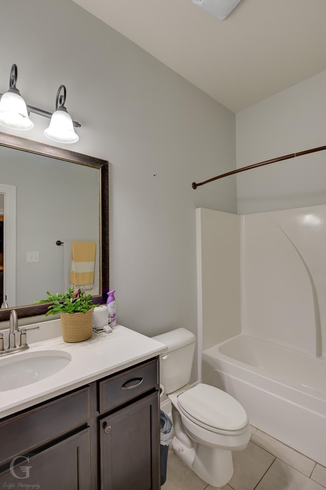 bathroom with bathing tub / shower combination, toilet, vanity, and tile patterned flooring