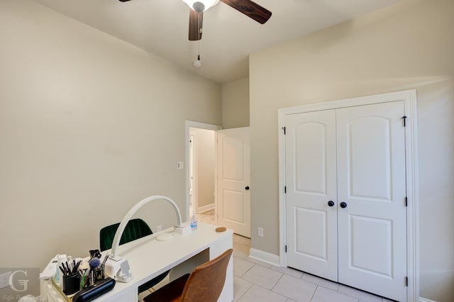 home office with light tile patterned floors, baseboards, and ceiling fan