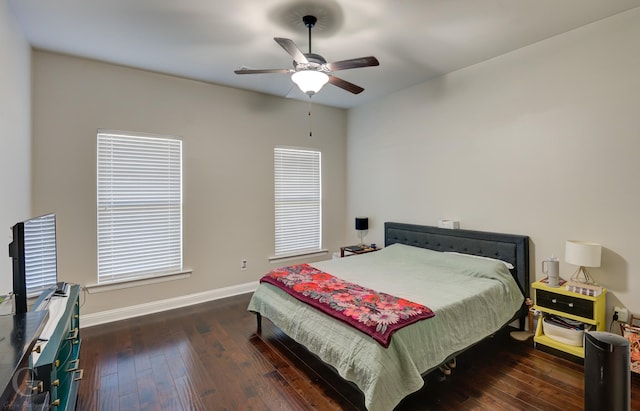 bedroom featuring hardwood / wood-style floors, a ceiling fan, and baseboards