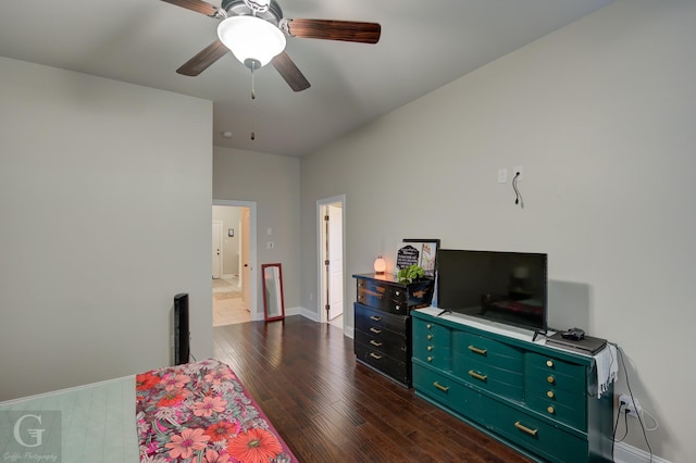 bedroom with baseboards, dark wood finished floors, and a ceiling fan