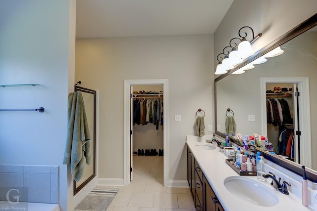 full bath featuring double vanity, tile patterned flooring, a shower stall, and a sink