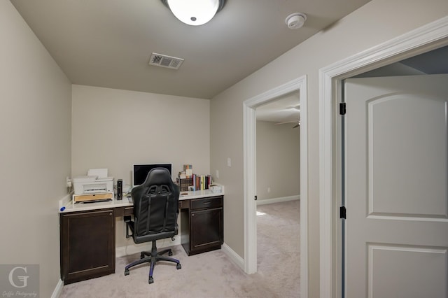 office area with visible vents, baseboards, and light colored carpet