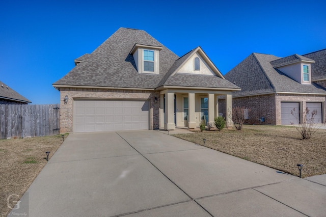 view of front of home featuring a garage, brick siding, driveway, and a shingled roof