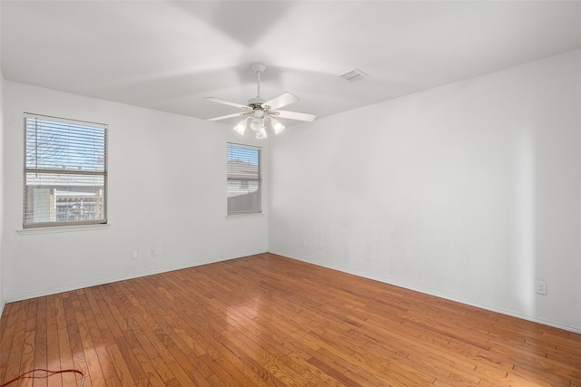 empty room with light hardwood / wood-style flooring and ceiling fan