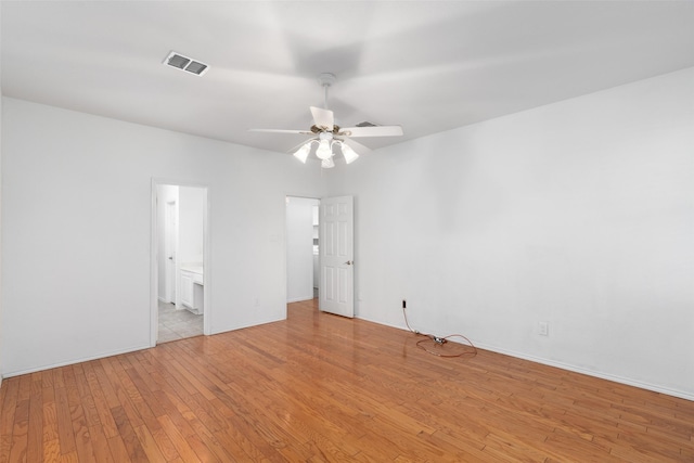 empty room with light wood-type flooring and ceiling fan