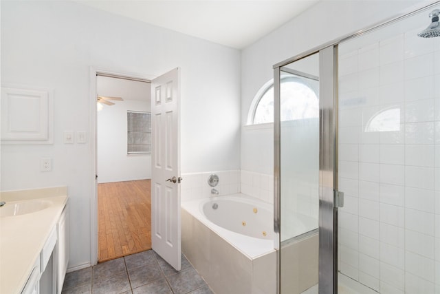 bathroom featuring tile patterned floors, vanity, ceiling fan, and plus walk in shower